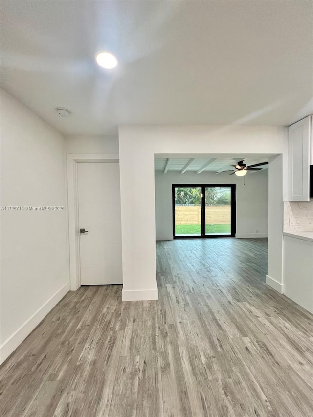 unfurnished room with ceiling fan and light hardwood / wood-style flooring