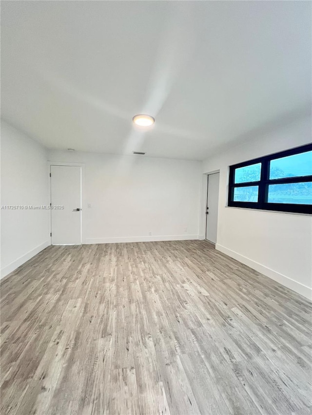 spare room with light hardwood / wood-style flooring