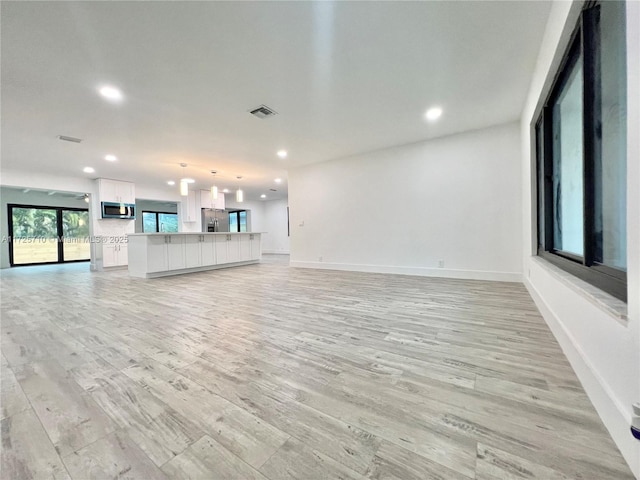 unfurnished living room with light hardwood / wood-style floors