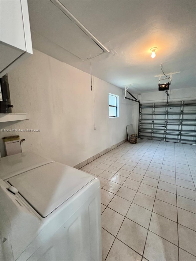 garage with washer and dryer and a garage door opener