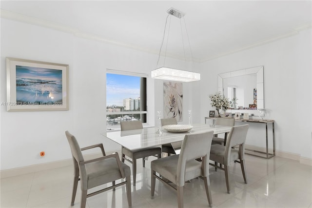 dining room with ornamental molding and light tile patterned floors