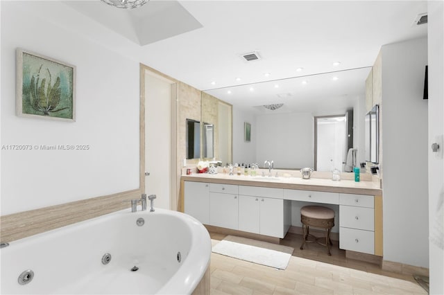 bathroom with vanity and a bathtub