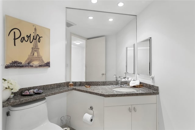 bathroom with toilet and vanity