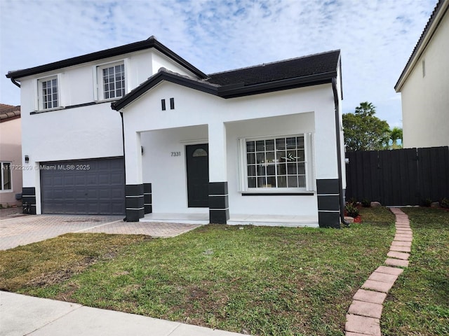 view of front of home featuring a front yard and a garage