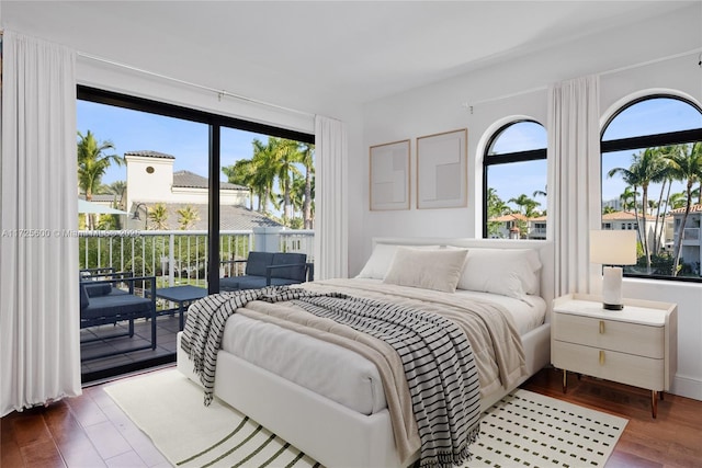 bedroom featuring access to exterior and dark hardwood / wood-style floors