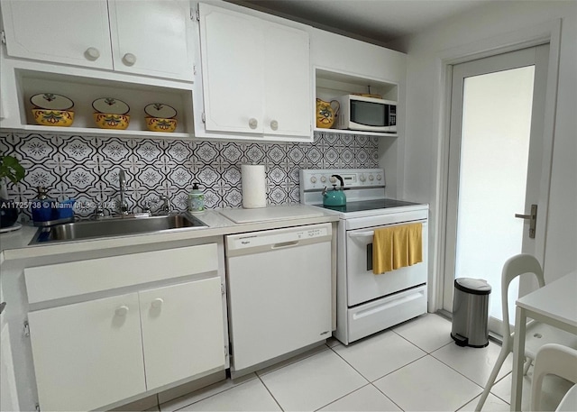 kitchen with sink, white appliances, backsplash, and white cabinets