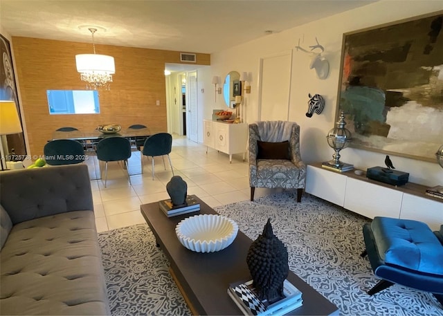 interior space featuring a notable chandelier, wooden walls, and light tile patterned flooring