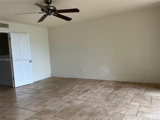 spare room with visible vents, baseboards, and a ceiling fan