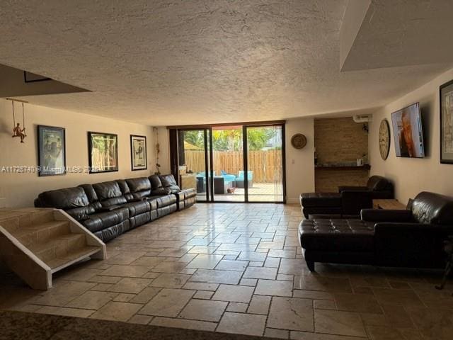 living room with a wall of windows and a textured ceiling