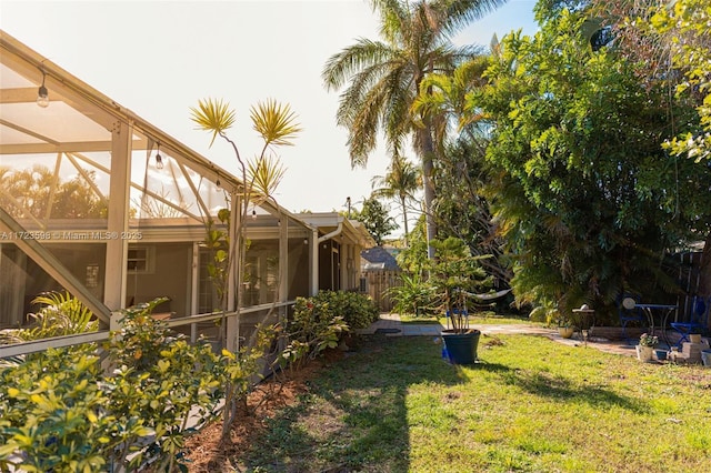 view of yard featuring glass enclosure