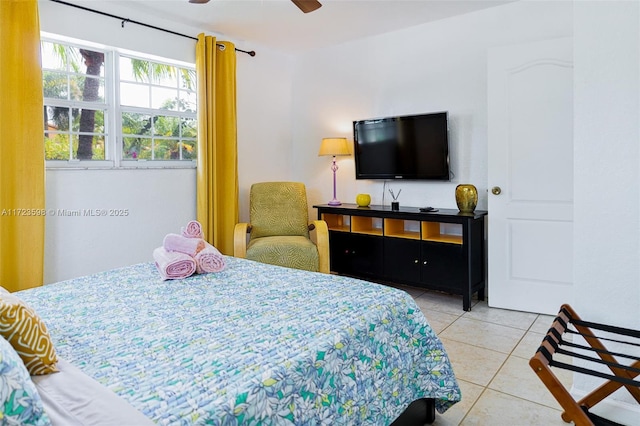 bedroom with ceiling fan and light tile patterned flooring