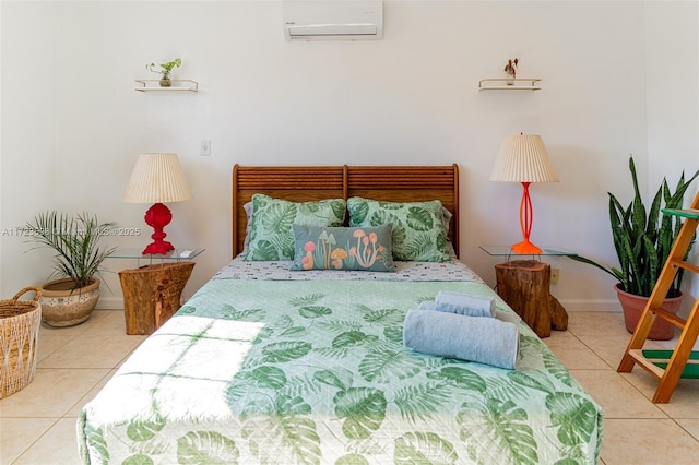 bedroom featuring light tile patterned floors and a wall mounted air conditioner