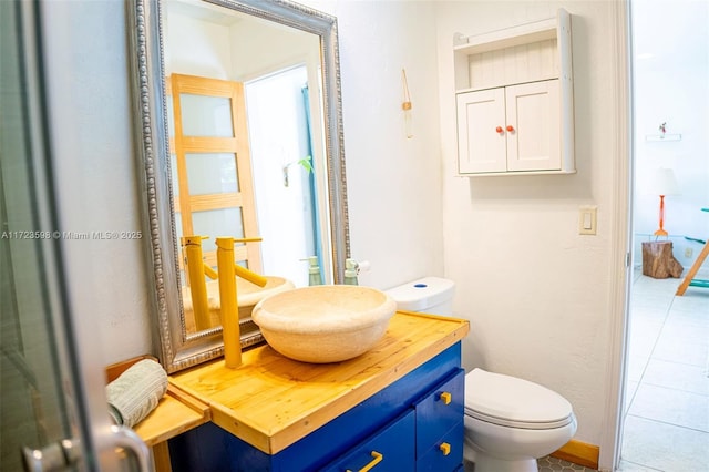 bathroom featuring vanity, toilet, and tile patterned floors