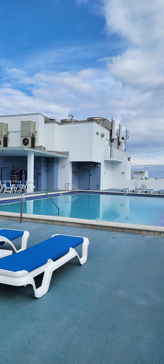 view of swimming pool with cooling unit