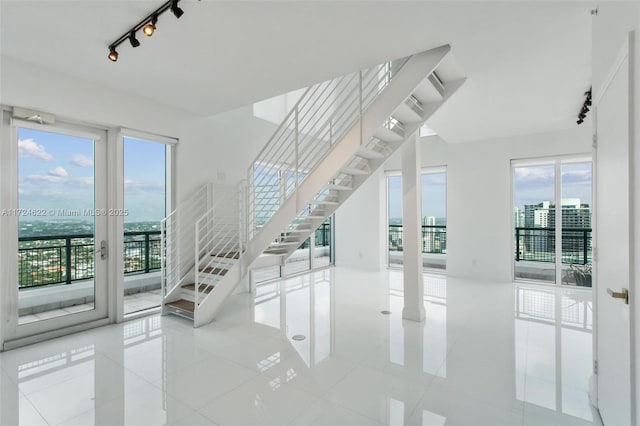 interior space with a healthy amount of sunlight, tile patterned flooring, and track lighting