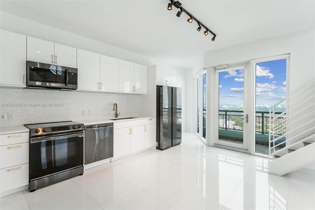 unfurnished living room featuring sink and light tile patterned floors