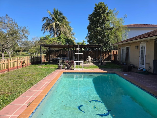 view of swimming pool featuring a patio area, a lawn, a fenced backyard, and a fenced in pool