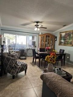 tiled living room featuring ceiling fan and crown molding