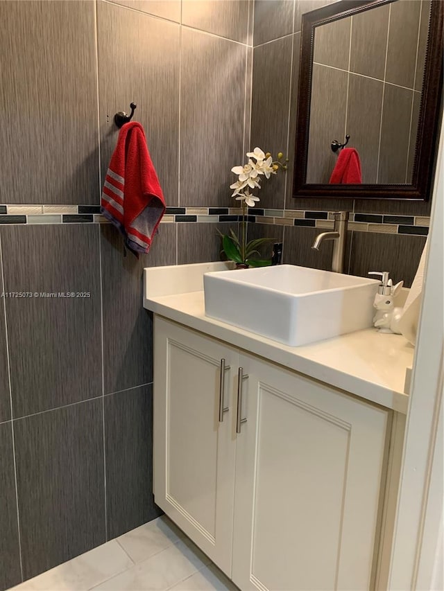 bathroom featuring tile patterned flooring, vanity, tile walls, and decorative backsplash