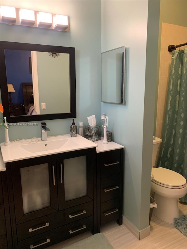 bathroom with toilet, wood-type flooring, vanity, and a shower with shower curtain