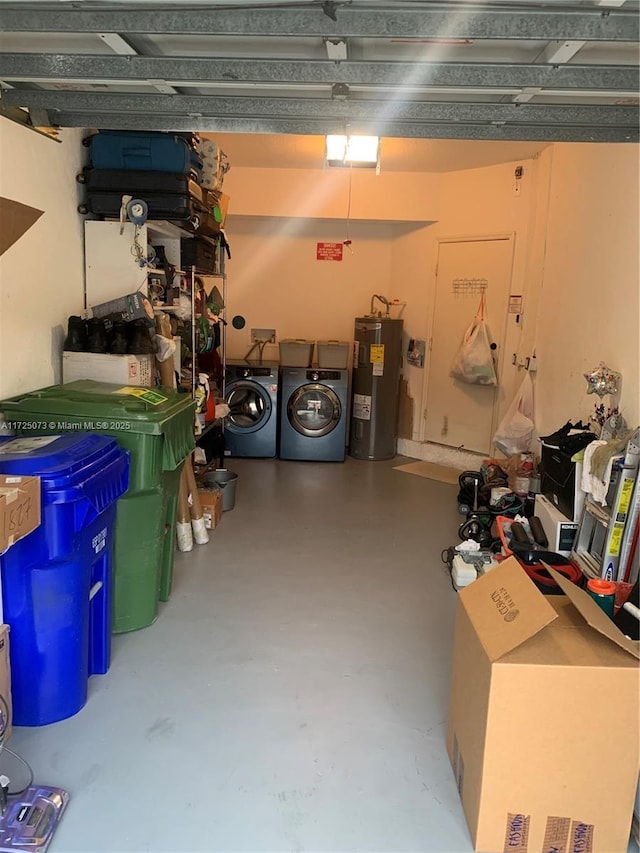 garage featuring electric water heater and independent washer and dryer