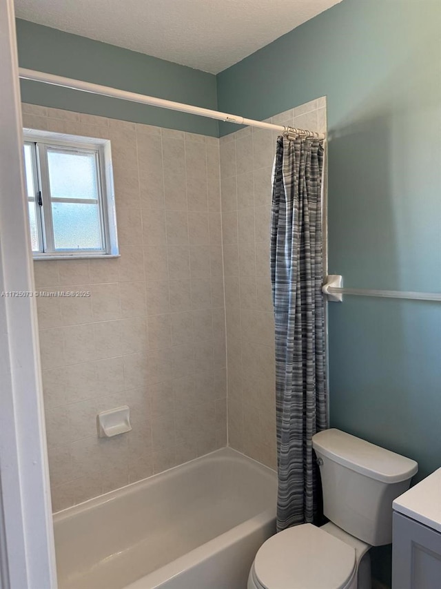 full bathroom featuring toilet, vanity, shower / bathtub combination with curtain, and a textured ceiling