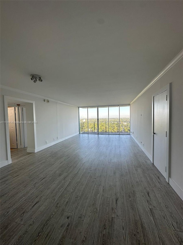 interior space with floor to ceiling windows, crown molding, and hardwood / wood-style floors