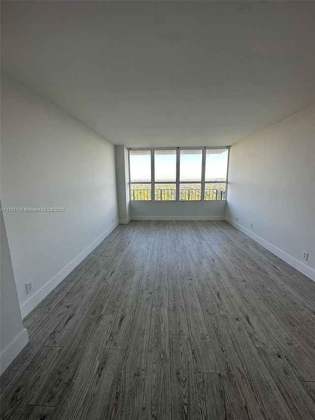 spare room featuring dark hardwood / wood-style floors