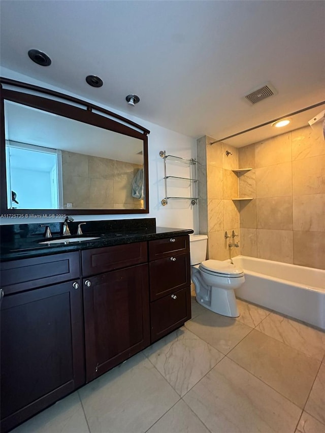 full bathroom with toilet, tiled shower / bath, and vanity