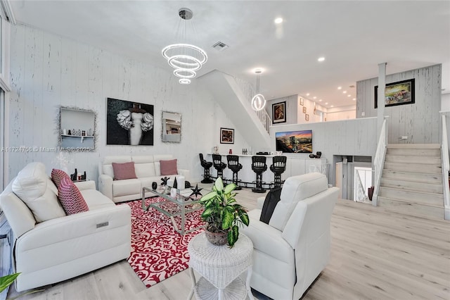 living room featuring an inviting chandelier and light wood-type flooring