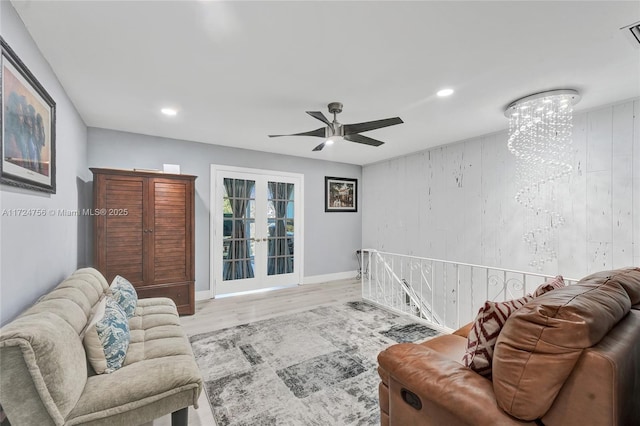 living room featuring light hardwood / wood-style flooring, ceiling fan, and french doors