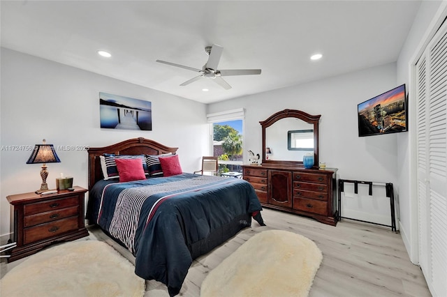 bedroom with light hardwood / wood-style floors, a closet, and ceiling fan