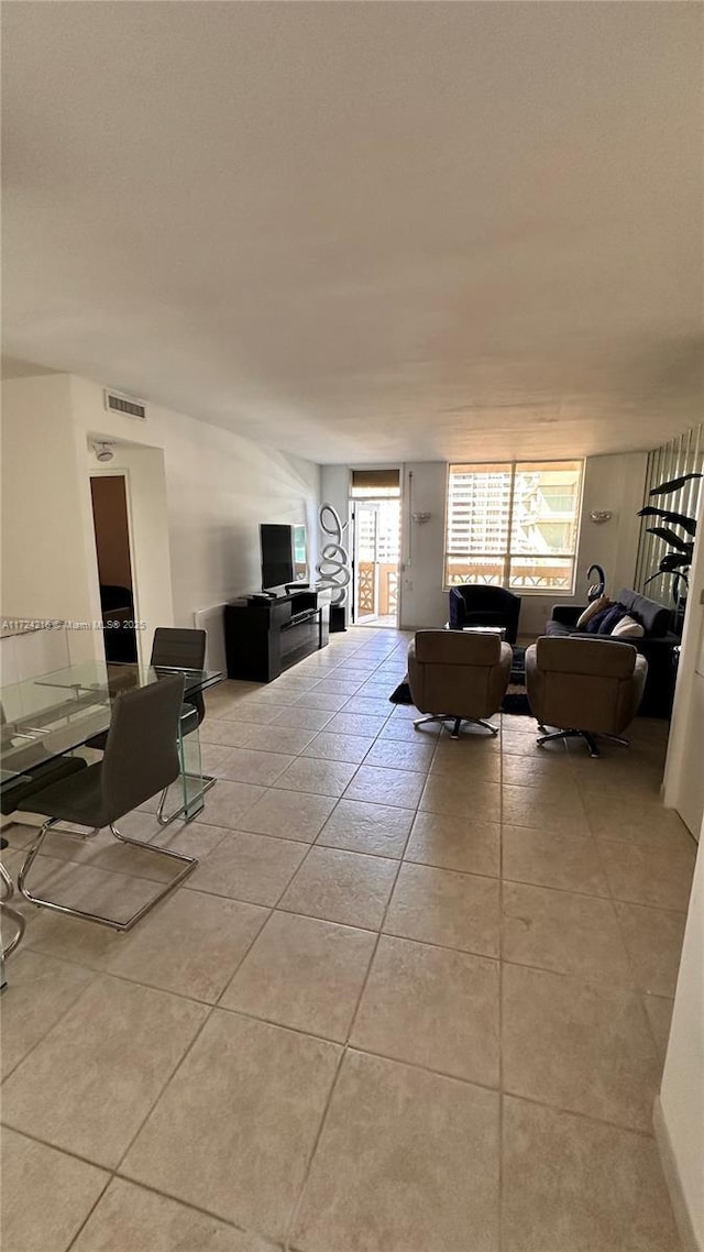 living room with light tile patterned floors and a healthy amount of sunlight