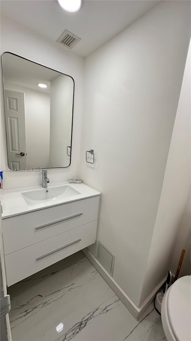 bathroom with toilet and vanity