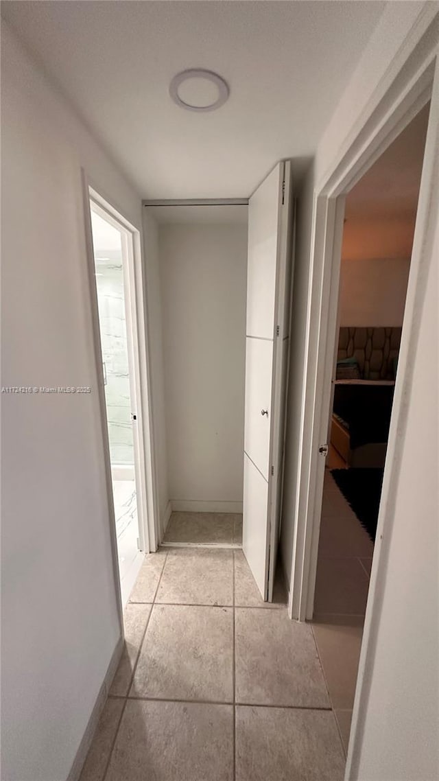 hallway with light tile patterned floors