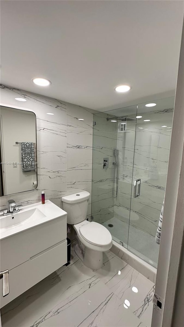 bathroom featuring walk in shower, vanity, and toilet