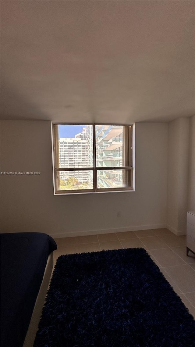 unfurnished bedroom with light tile patterned floors