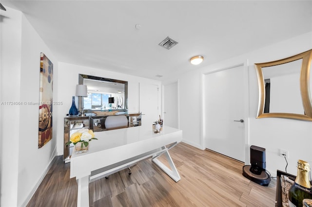 home office with hardwood / wood-style flooring