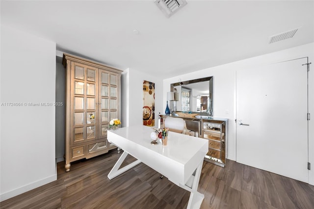 office space featuring dark hardwood / wood-style flooring and beverage cooler