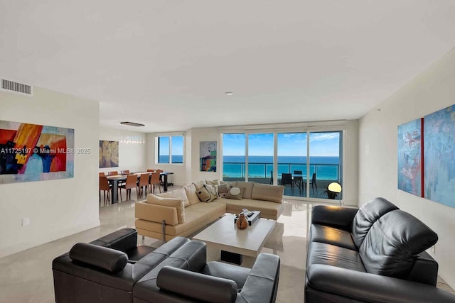 living room featuring a water view and a wealth of natural light