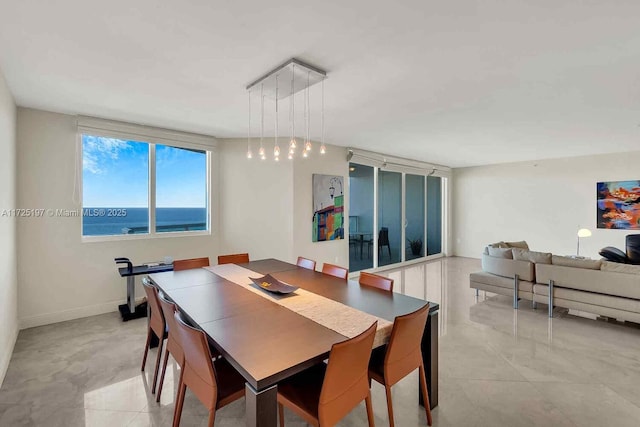 dining space featuring a water view