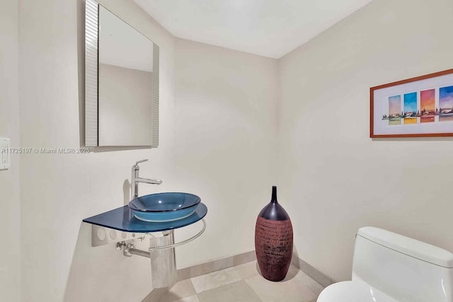 bathroom with sink, tile patterned floors, and toilet