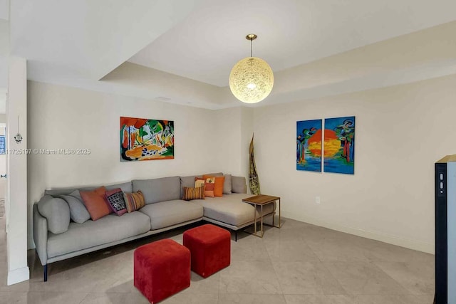 living room with a tray ceiling