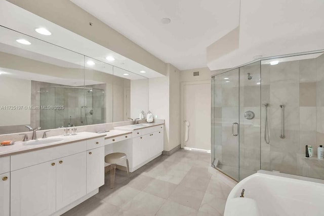 bathroom featuring vanity and shower with separate bathtub