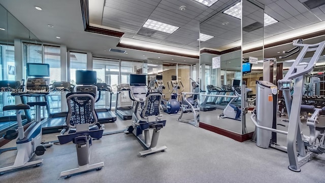 exercise room featuring a raised ceiling