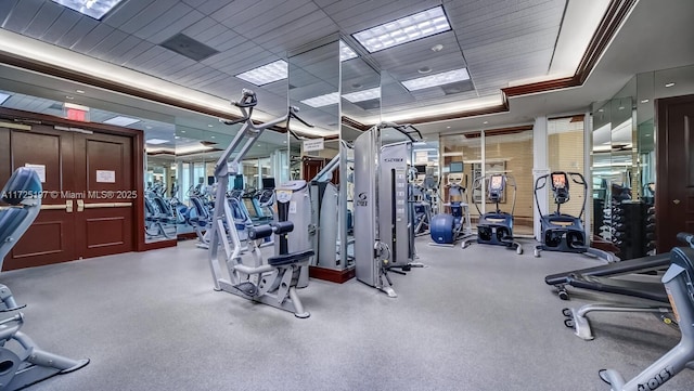 exercise room with a tray ceiling