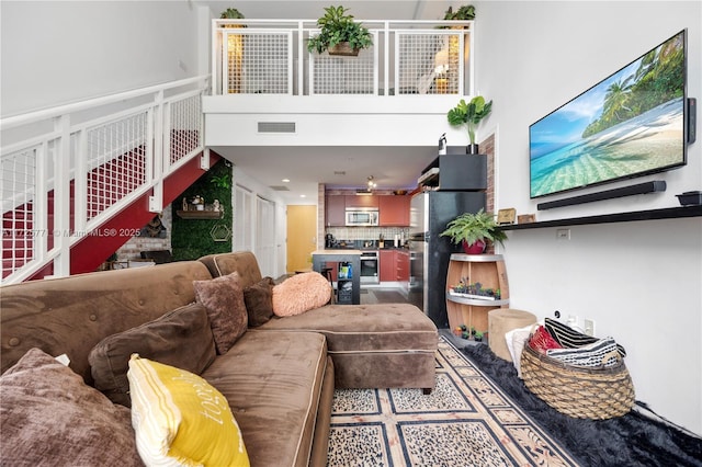 living room with a high ceiling and hardwood / wood-style flooring