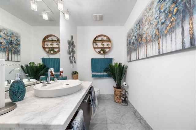 bathroom featuring toilet and vanity