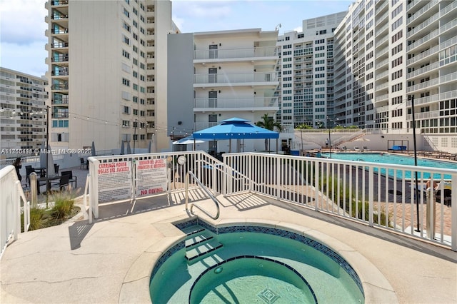 view of swimming pool with a community hot tub