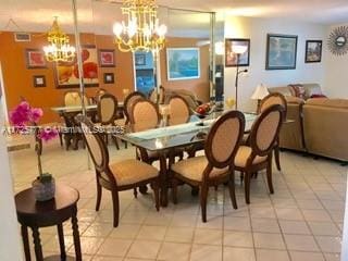 tiled dining area with a chandelier